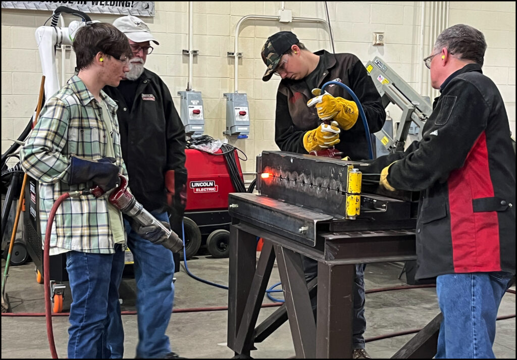 Photo: Nan Jackson, 2024 Student prepares to drive a rivet during demo at Lansing Community College West Campus.