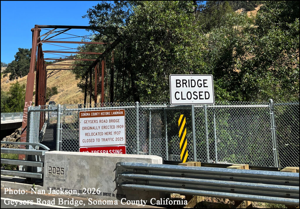 Photo Nan Jackson 2026 Galvanized chain-link fence newly erected at the bridge’s approaches. Large signs are attached at each end of the bridge: “Sonoma County Landmark. Geysers Road Bridge, originally erected in 1909, relocated here in 1937, closed to traffic 2025. NO TRESPASSING.”